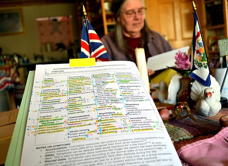 Diane Schou of Green Bank, WV, pictured with her catalogued list of the symptoms of electrosensitivity.